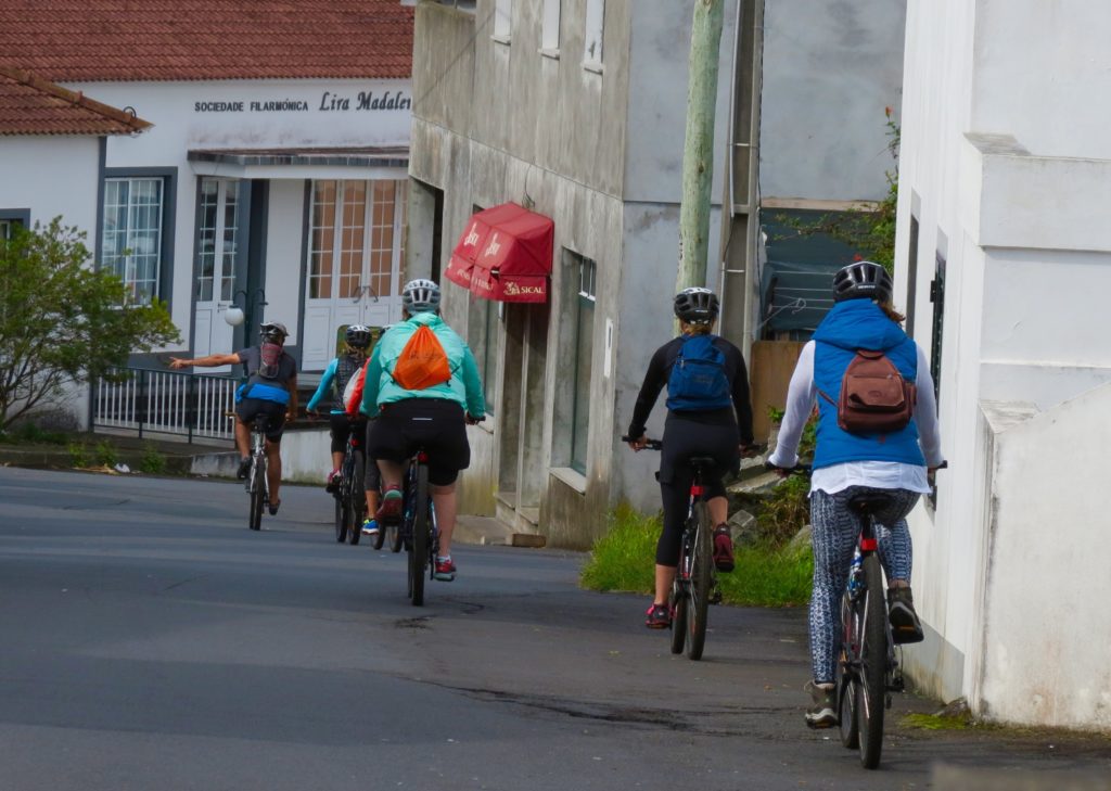 People riding bikes in street of Portugal