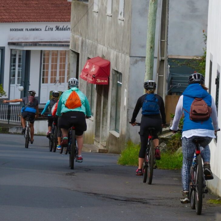 People riding bikes in street of Portugal